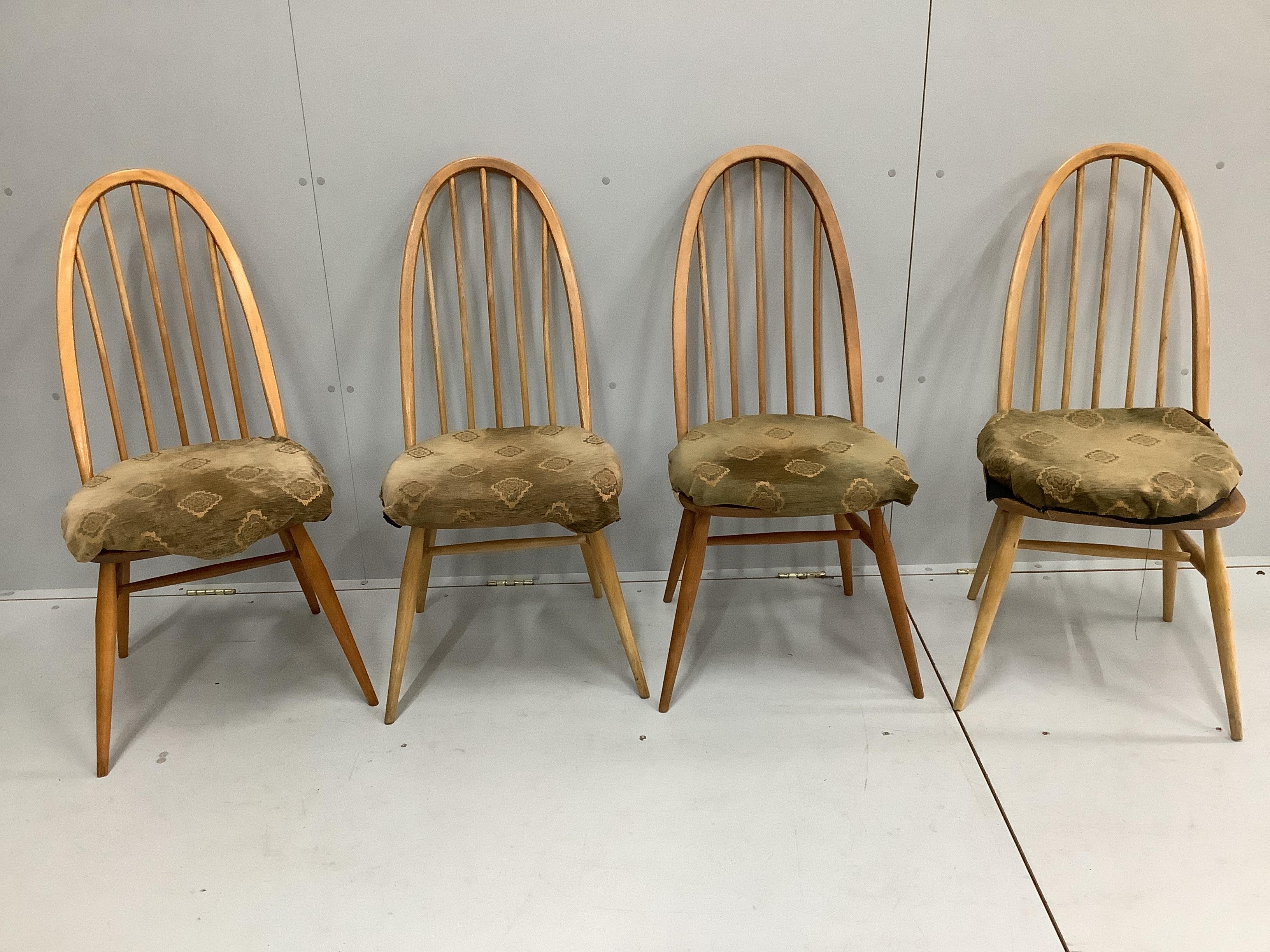 An Ercol elm and beech rectangular extending dining table, 224cm extended, width 88cm, height 71cm together with four Ercol elm and beech comb back dining chairs